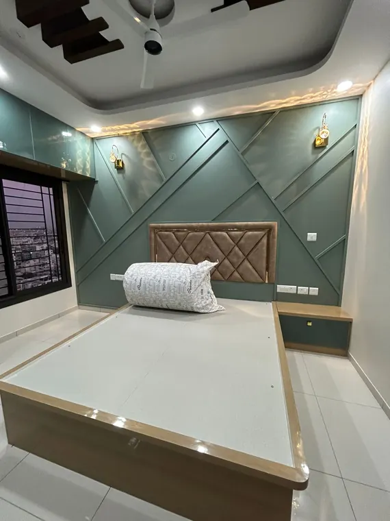 Bedroom with emerald feature wall and platform bed