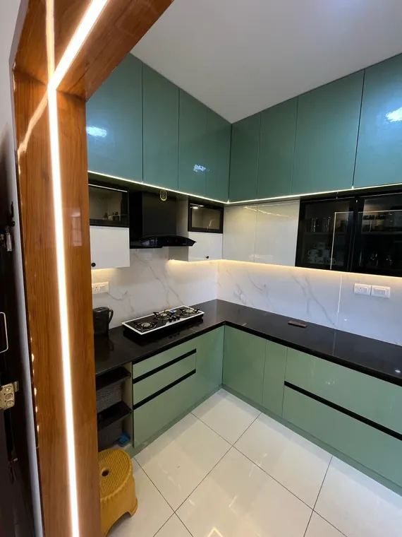 Emerald-green U-shaped modular kitchen with marble backsplash