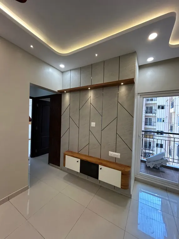 Living room with geometric panelled feature wall and balcony